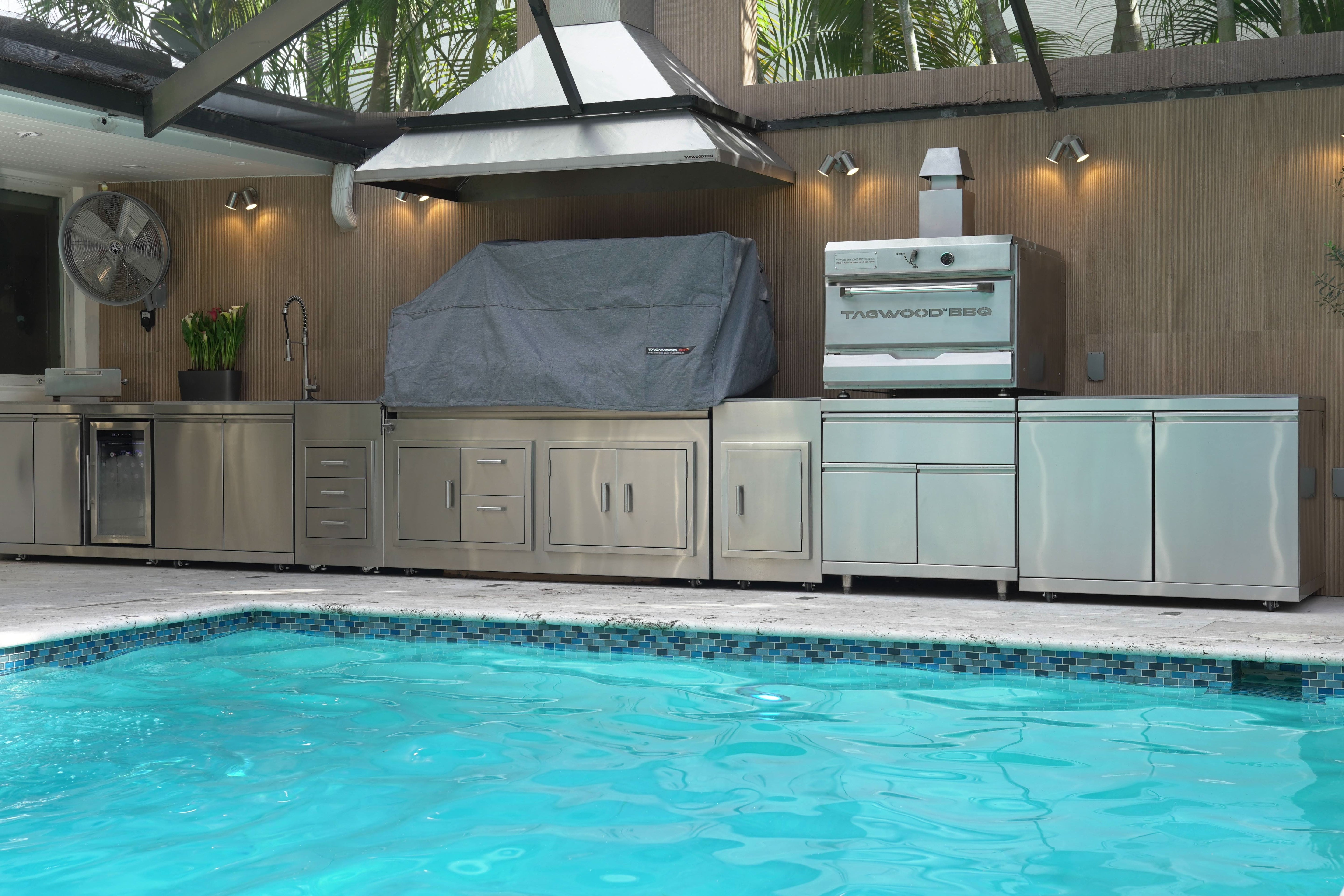 Outdoor kitchen next to a pool -smokeforges