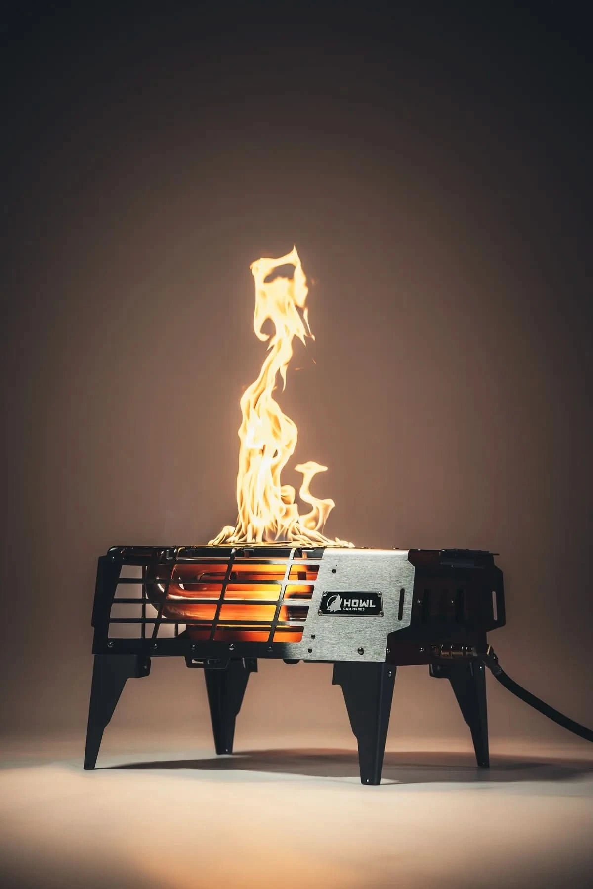 Portable fire pit with flames on a dark background