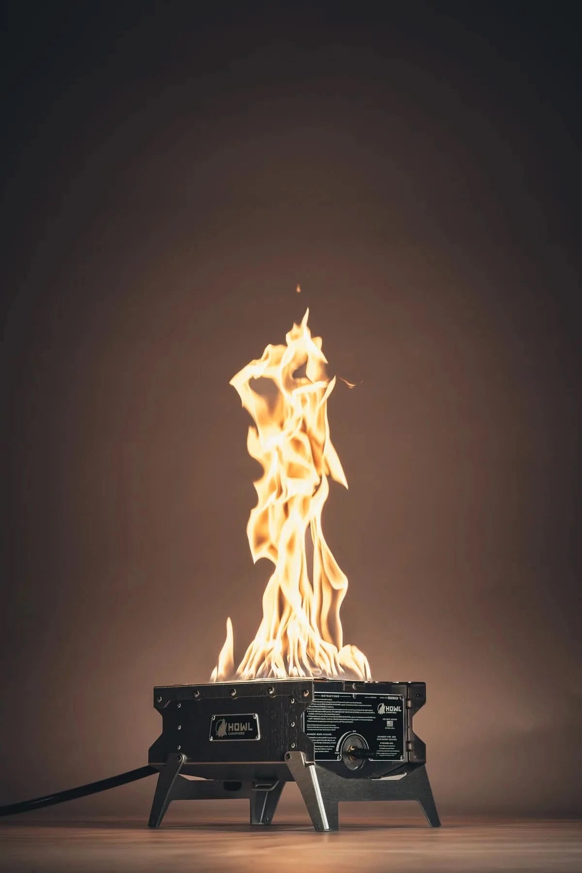 Portable stove with flames on a dark background