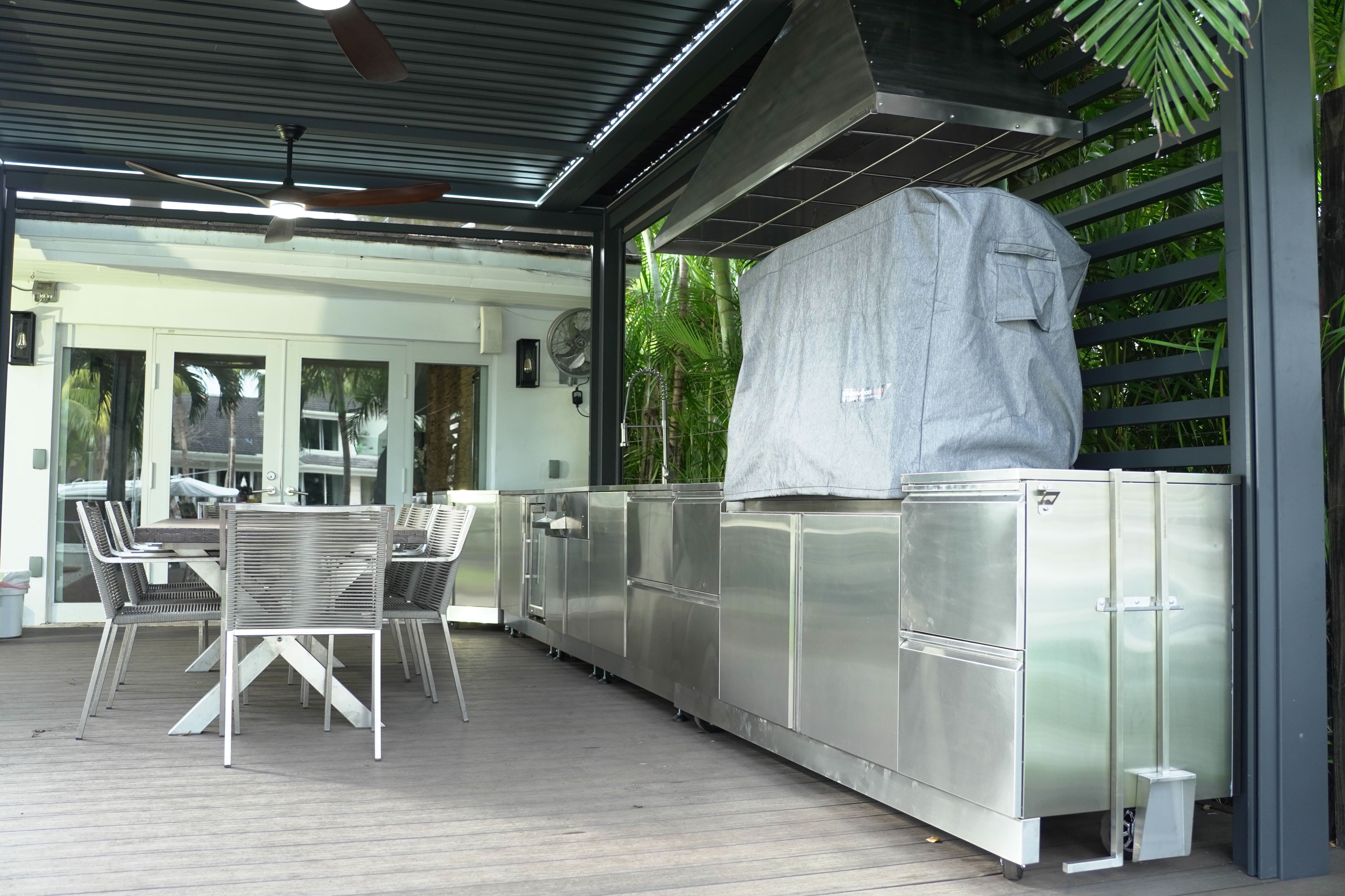 An outdoor kitchen with a grill -smokeforges