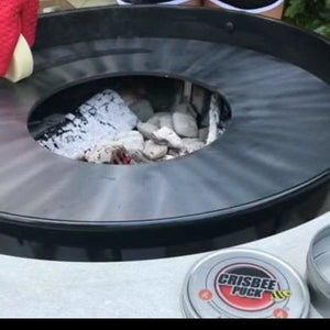 Crisbee Puck next to a grill -smokeforges