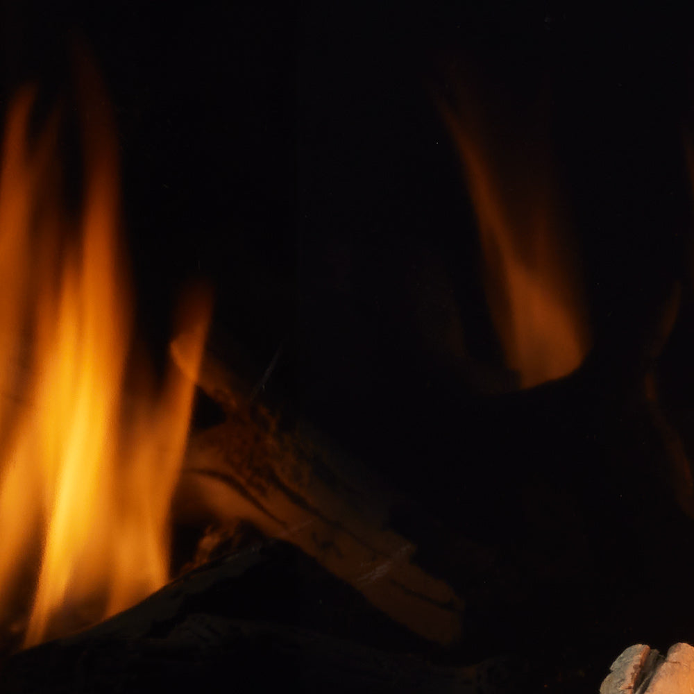 Majestic reflective black glass fireplace liner — representative installed example