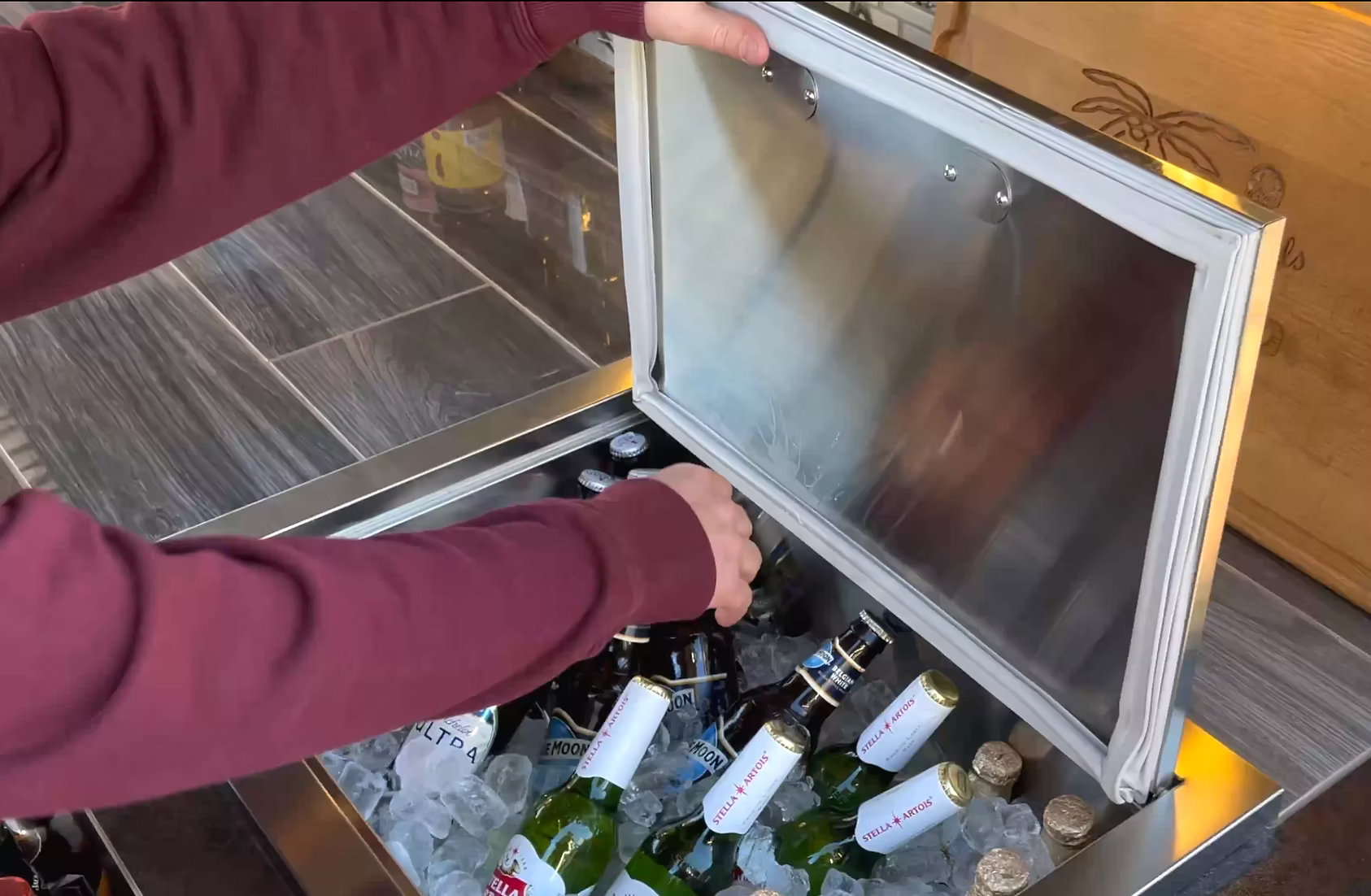 KoKoMo drop-in ice bin installed in an outdoor kitchen bar with drinks and ice