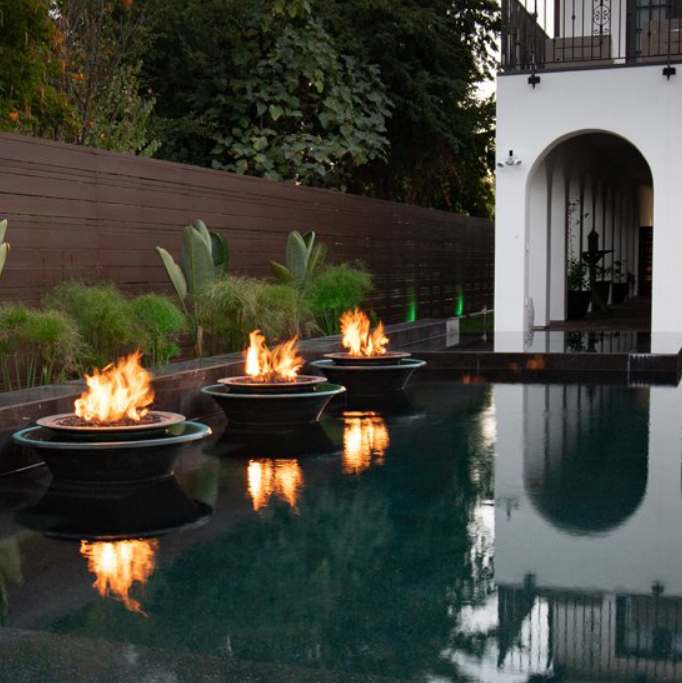 The Outdoor Plus Cazo Fire and Water Bowl Copper 360 Spill installed beside a pool