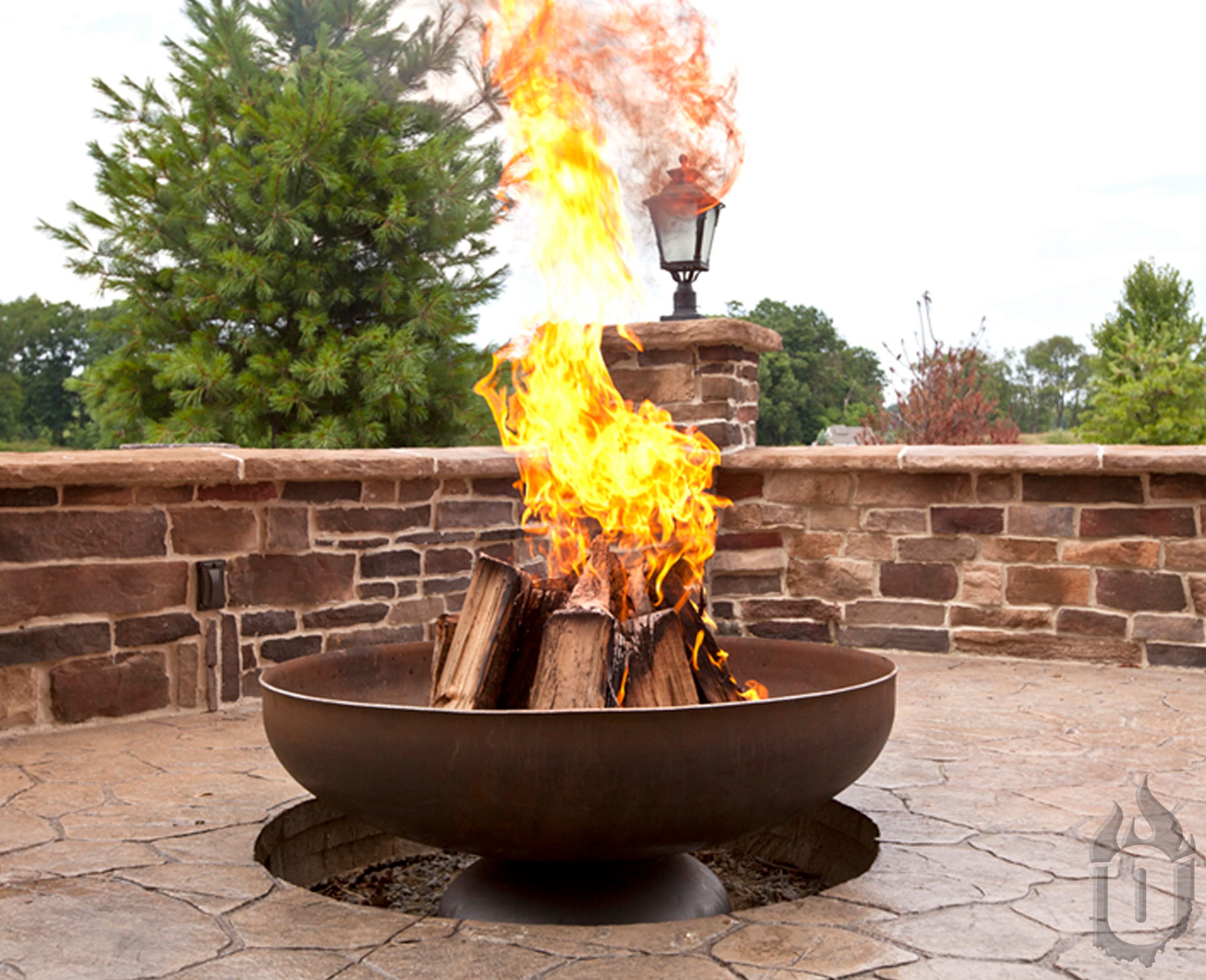 Ohio Flame Patriot steel fire pit with wood burning inside the bowl