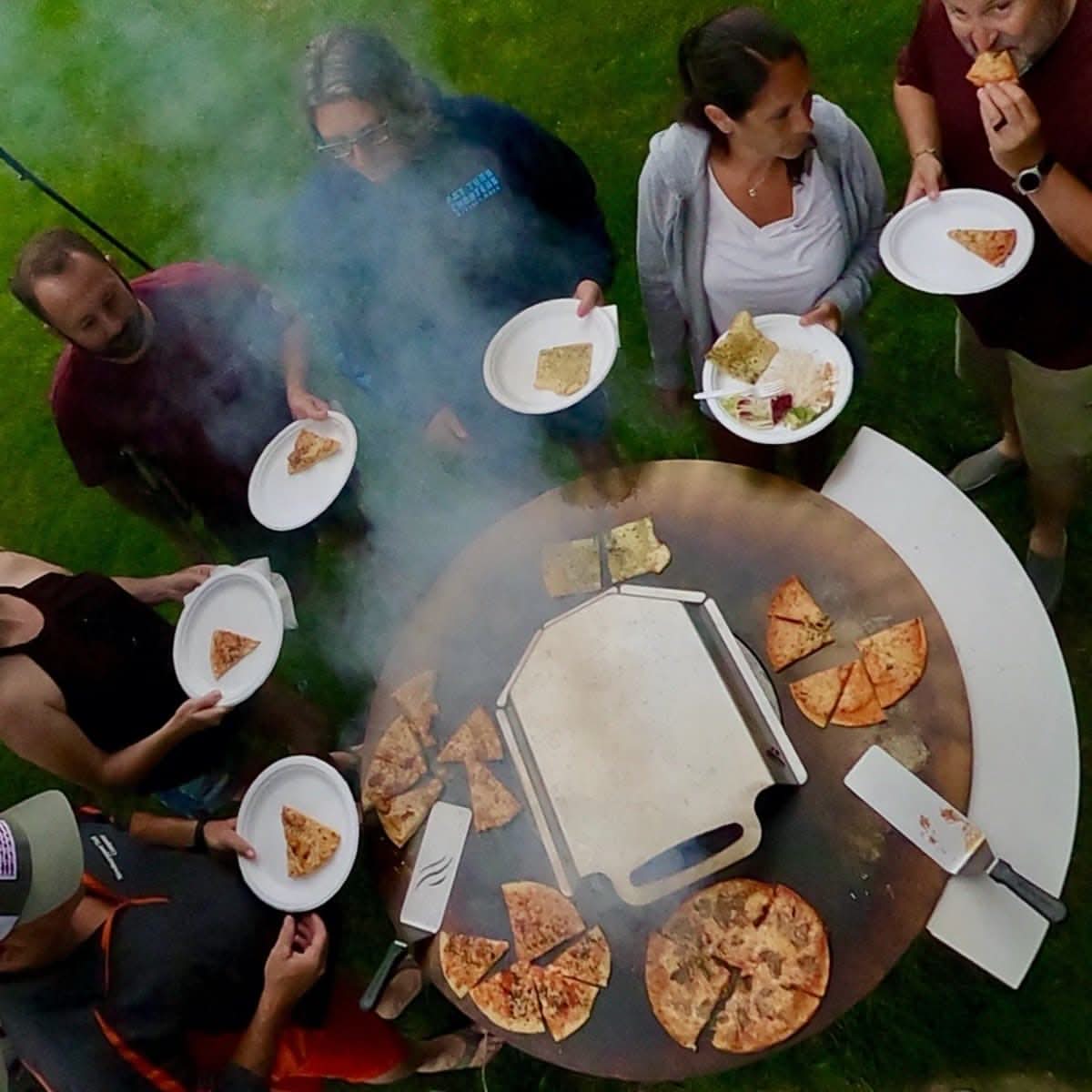 Arteflame pizza oven kit in use outdoors with pizzas on the grill