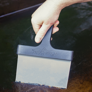 Char-Griller 8977 scraper cleaning a Flat Iron griddle
