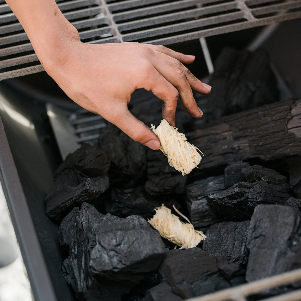 Char-Griller natural wood fire starter placed with charcoal