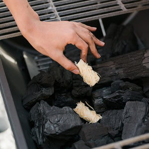 Char-Griller natural wood fire starter placed with charcoal