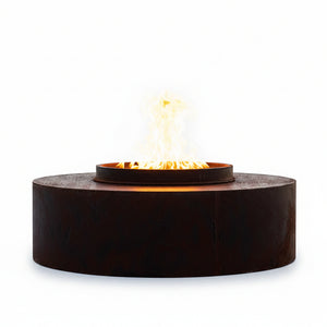 Fire pit with flames burning on a stone surface during sunset.
