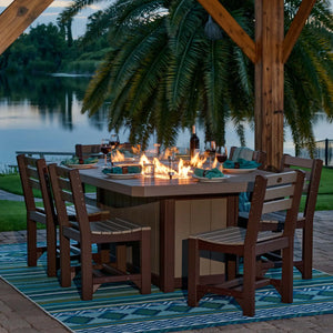 Luxcraft 79-inch Lumin fire table in a tropical outdoor dining setting