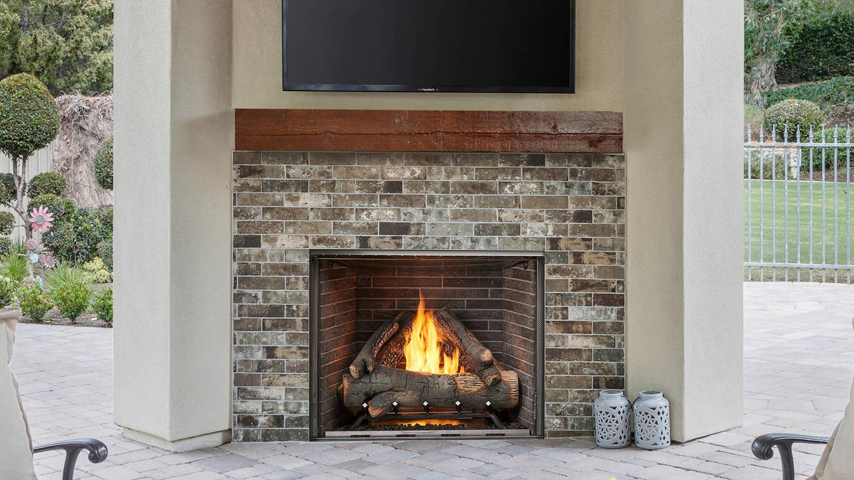 Majestic Courtyard 36 outdoor gas fireplace in a brick hearth on a patio
