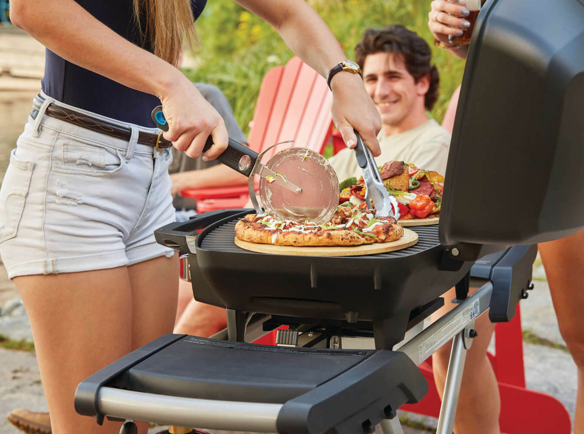 Napoleon TravelQ PRO285X Propane Grill with Scissor Cart - Napoleon portable outdoor grill product and lifestyle image