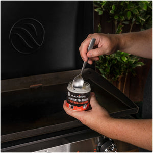 Blackstone Griddle Seasoning and Cast Iron Conditioner — applying conditioner to a griddle