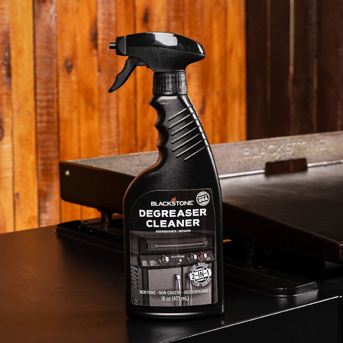 Blackstone Spray Degreaser Cleaner — bottle beside an outdoor griddle