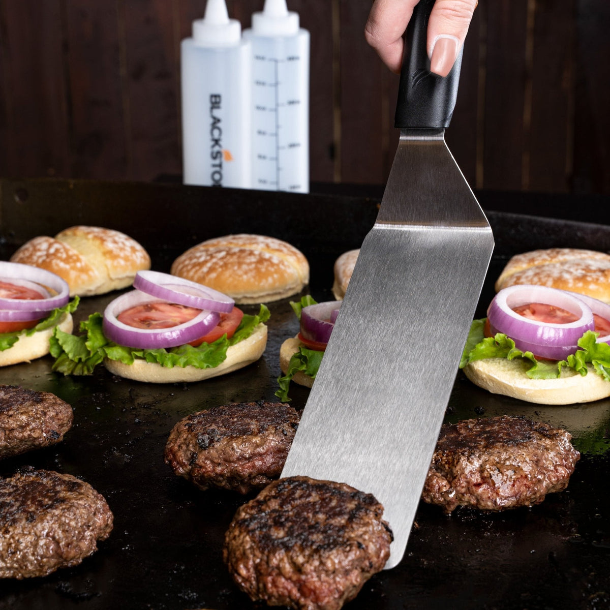 Blackstone Griddle Essentials Toolkit – 5 Piece — spatulas turning burgers