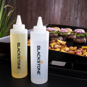 Blackstone Griddle Essentials Toolkit – 5 Piece — squeeze bottles beside the cooking surface