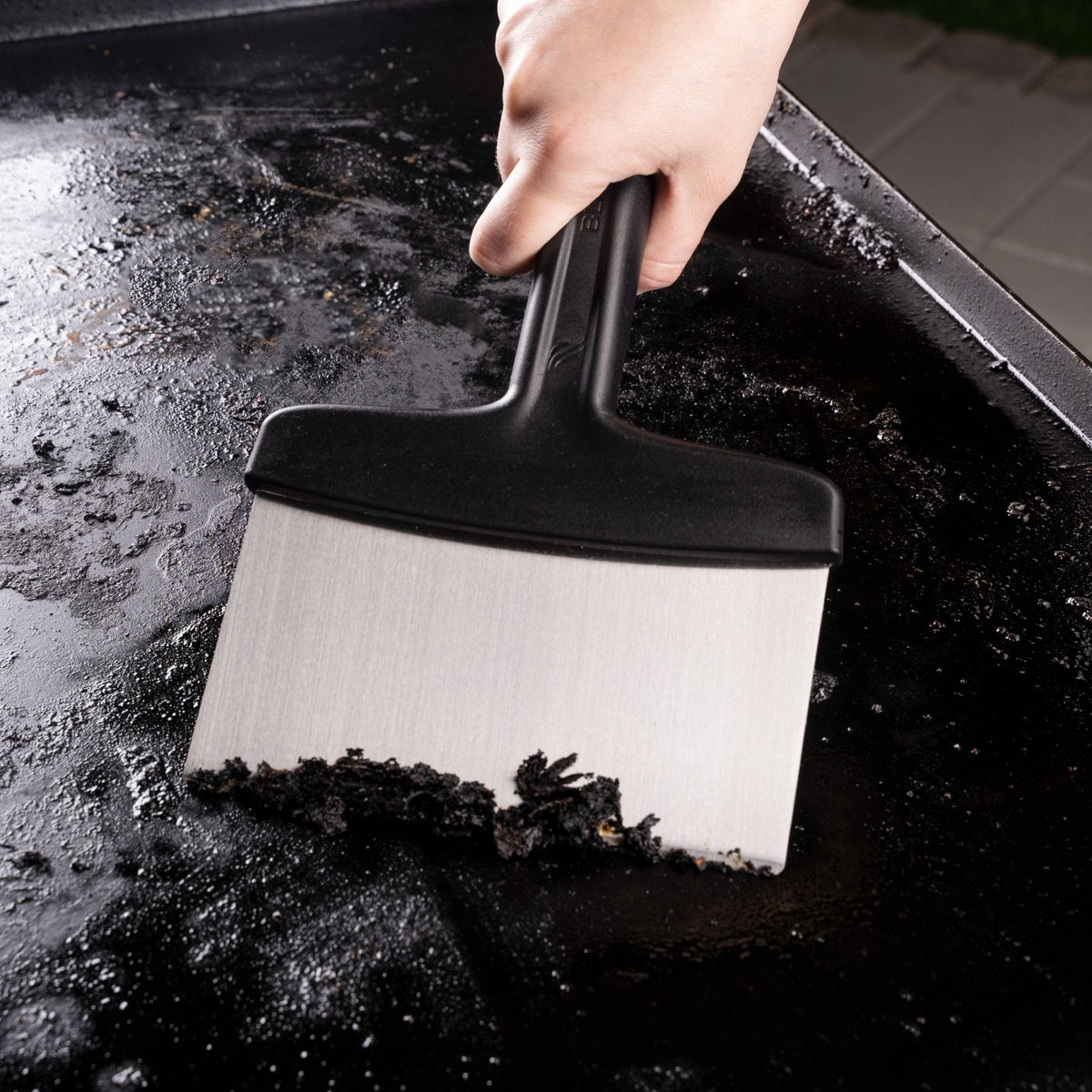 Blackstone Griddle Essentials Toolkit – 5 Piece — scraper cleaning the griddle