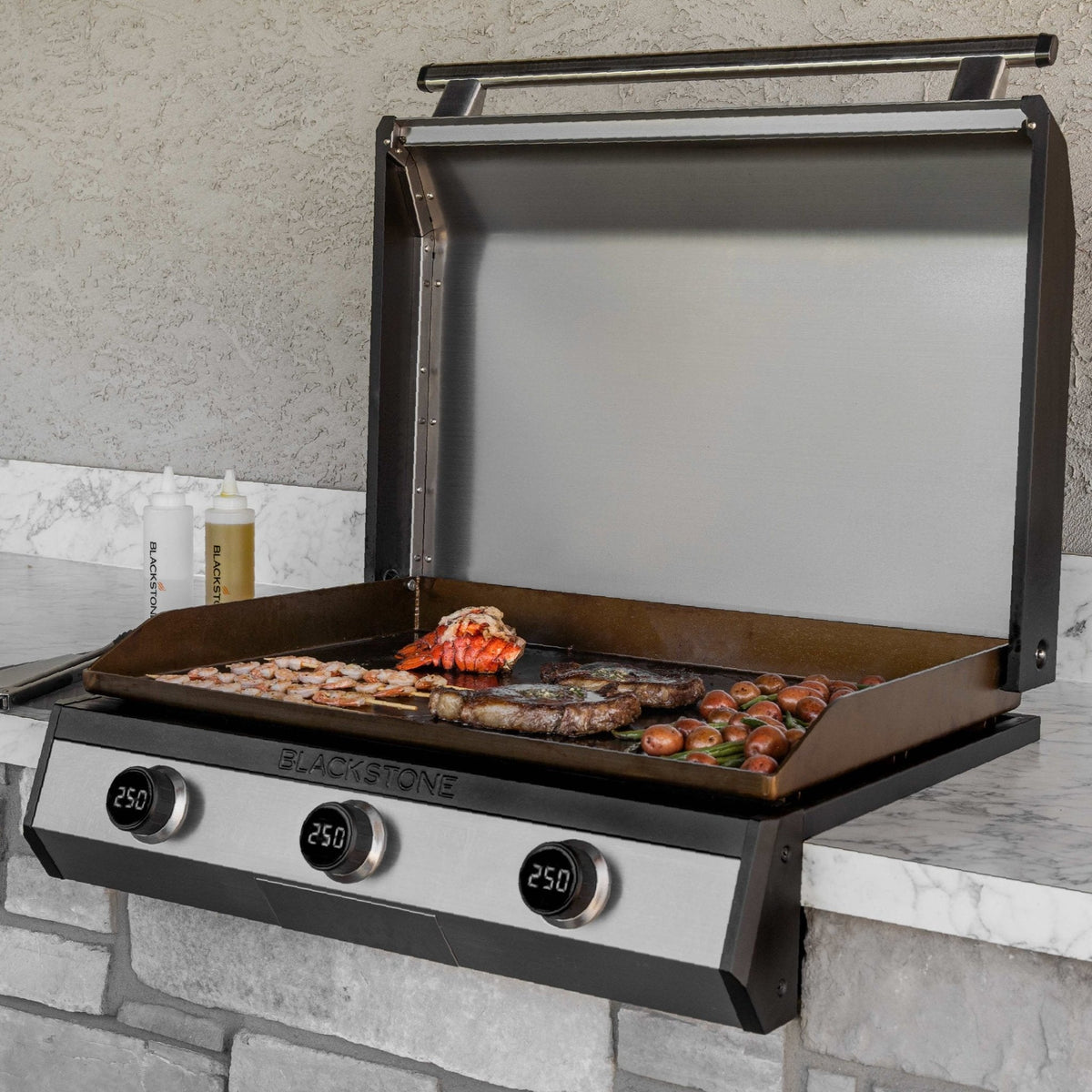 Blackstone 30-Inch Electric Drop-In Griddle — installed in an outdoor kitchen with food on the griddle