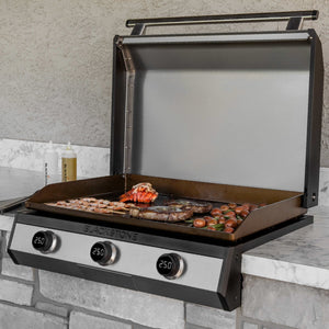 Blackstone 30-Inch Electric Drop-In Griddle — installed in an outdoor kitchen with food on the griddle