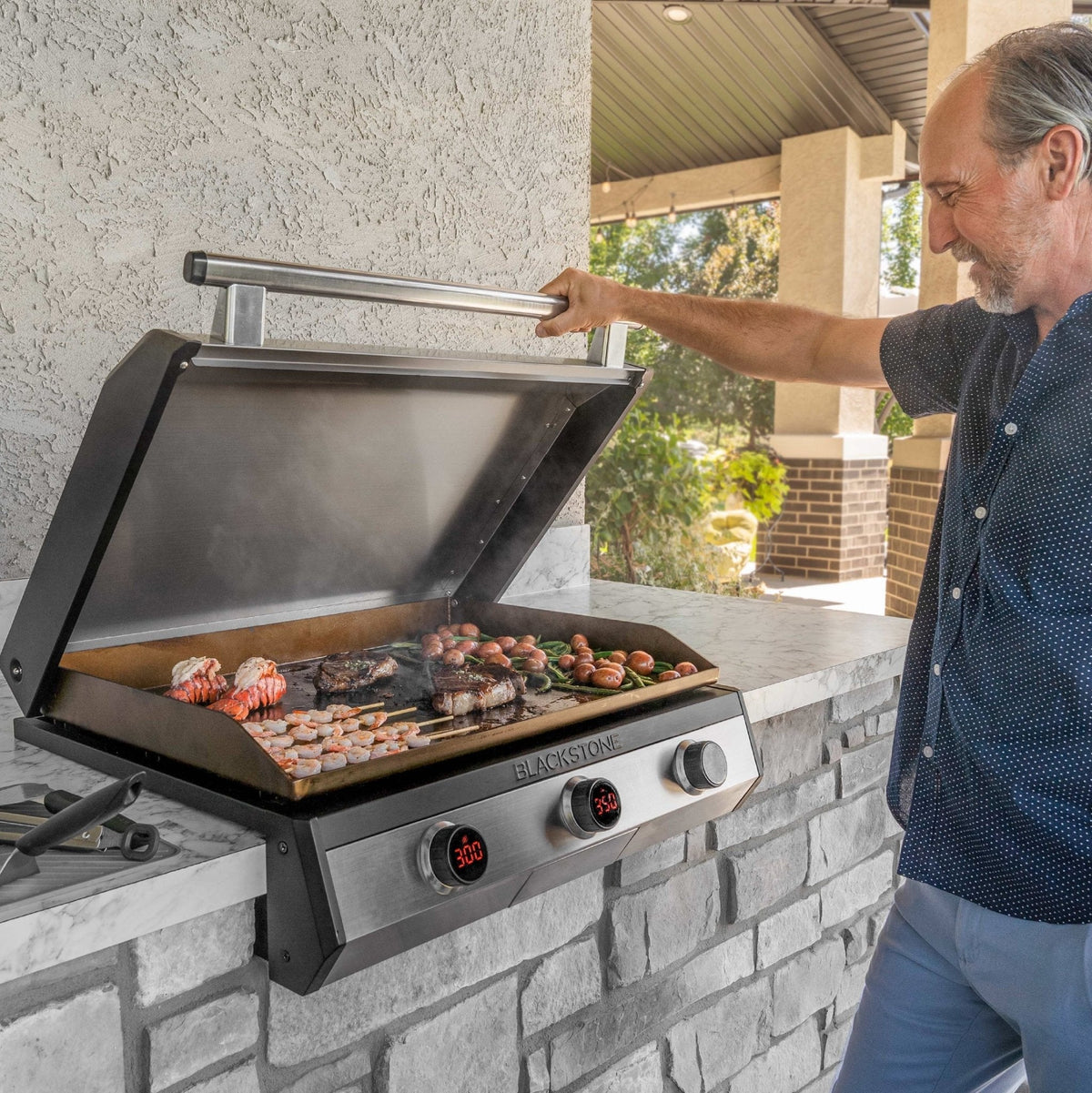 Blackstone 30-Inch Electric Drop-In Griddle — hood open in an outdoor kitchen