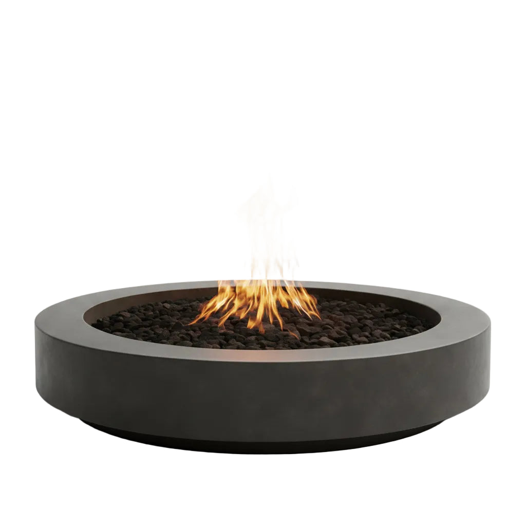 Modern fire pit with flames in a natural setting with mountains and a lake.